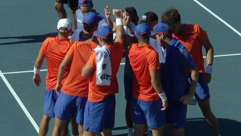 The Gator men's tennis team circles up before their match against Miami.