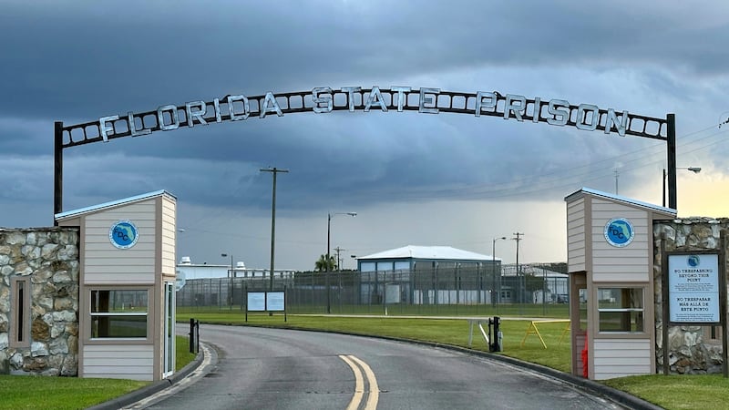 FILE - Clouds hover over the entrance of the Florida State Prison in Starke, Fla., Aug. 3, 2023.