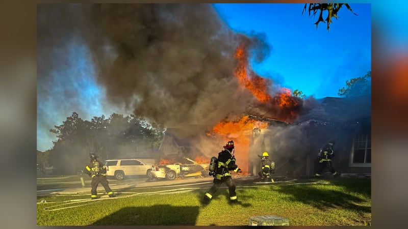 Fire spread to car in driveway; no injuries reported